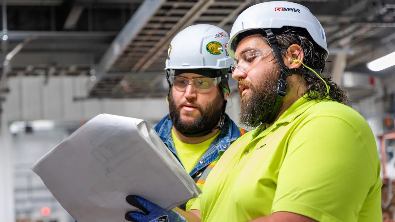 construction workers reviewing plans on site