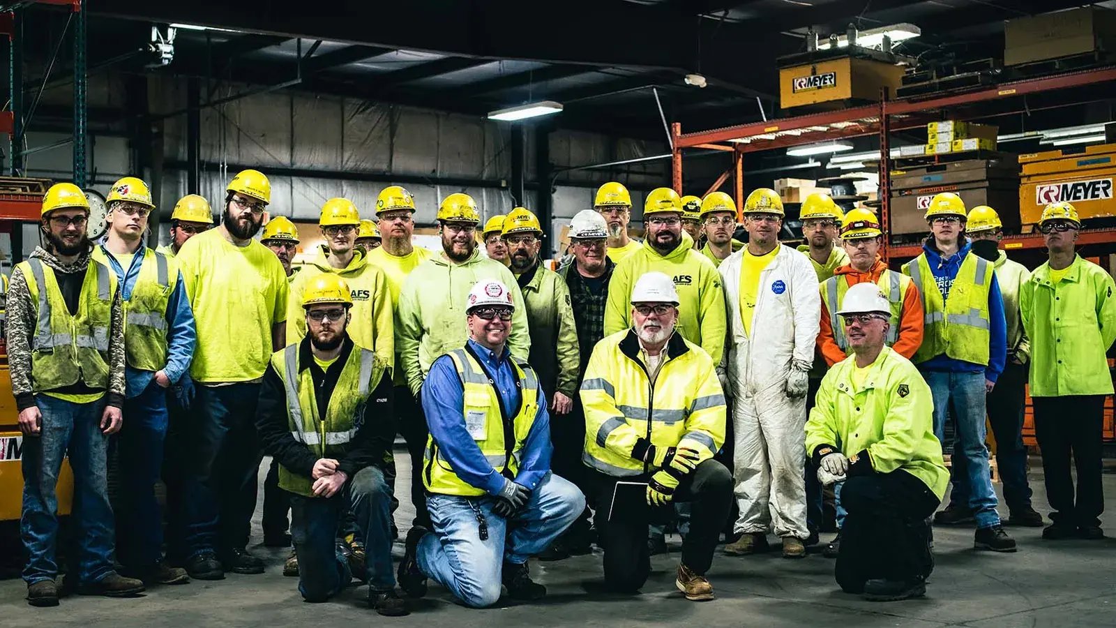 industrial workers group portrait warehouse safety gear