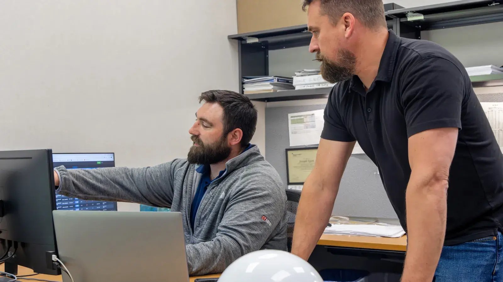 two men collaborating at computer