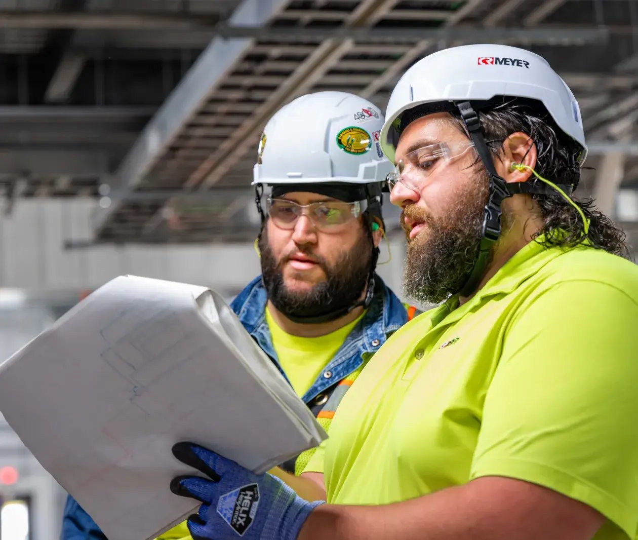 construction workers reviewing plans on site