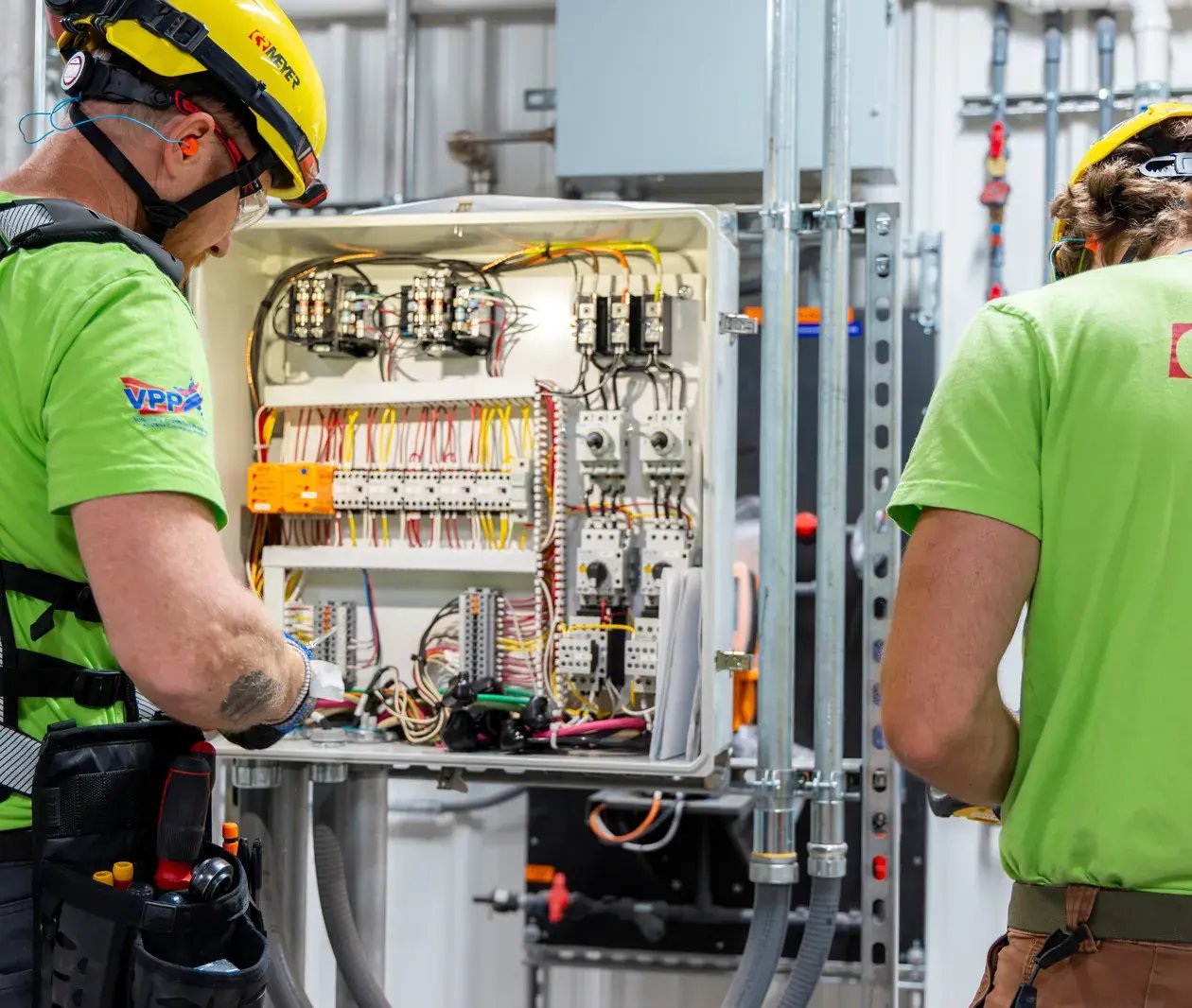 electricians working on control panel