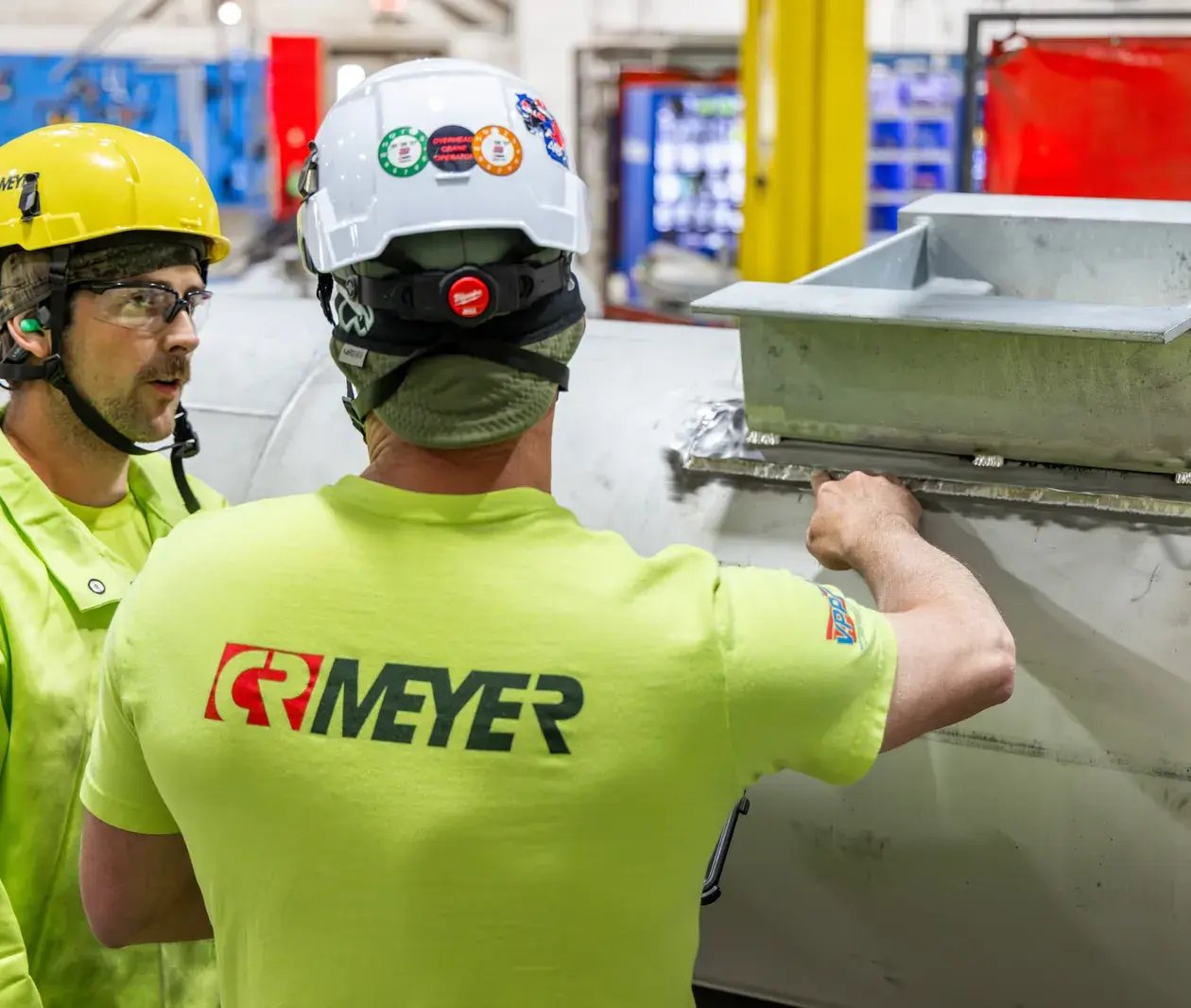 industrial workers inspecting fabricated part