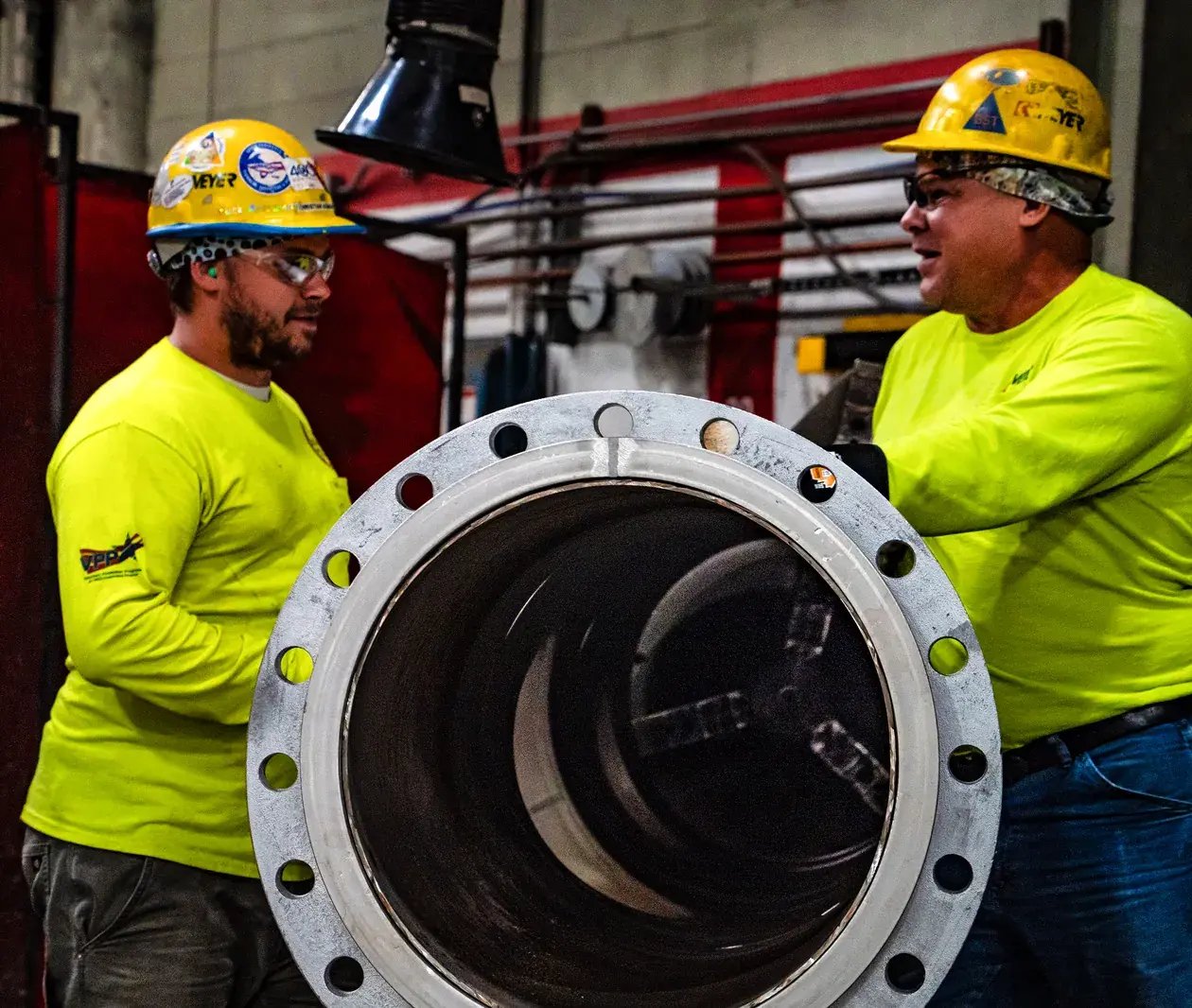 industrial-workers-inspecting-large-pipe-1260x1066