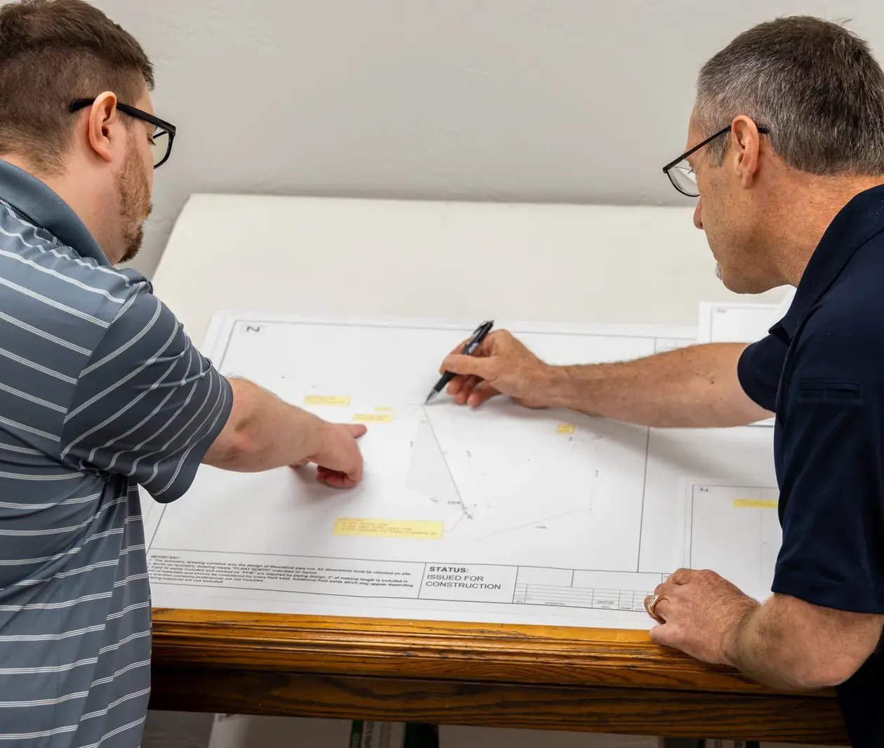 two men reviewing construction plans