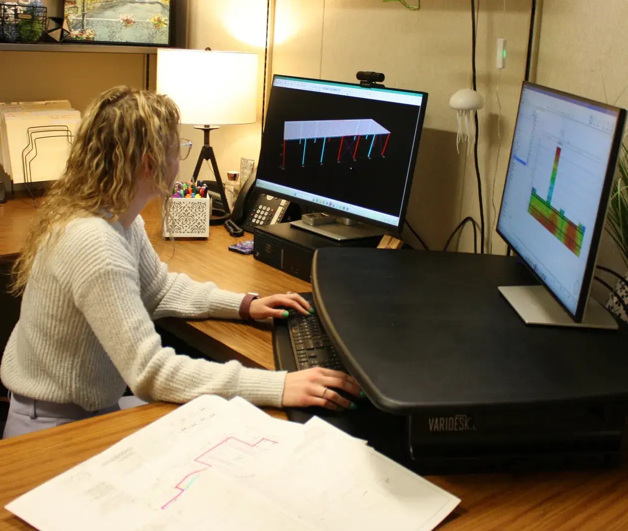 woman engineer working dual monitors structural design