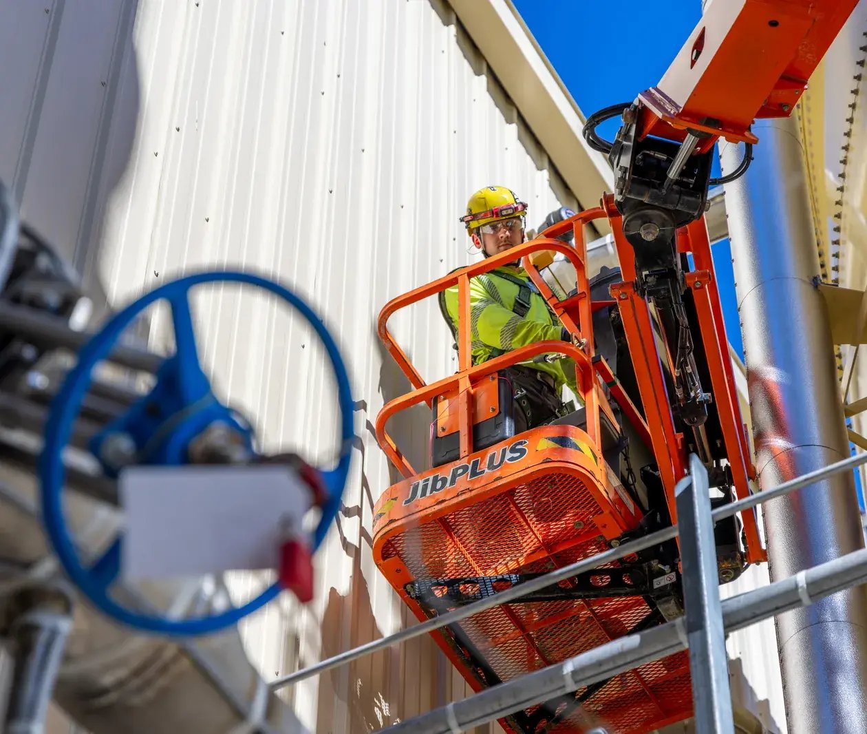 worker-on-boom-lift-industrial-building-maintenance-1260x1066